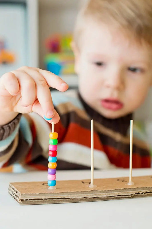 Toddler playing with toys to develop fine motor skills through fun activities